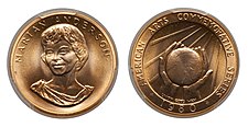 A gold medallion depicting a woman and cupped hands holding a globe