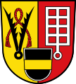 Gemeinde Walsdorf Gespalten von Gold und Rot, im Schildfuß belegt mit einem schwarzen Schild, darin ein goldener Balken; vorne eine schwarze Pferdebremse, unterlegt mit einem roten Lederseil, hinten ein silberner Rost.[30]