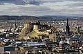 Image 21Edinburgh Castle is a fortress which dominates the skyline of the city of Edinburgh, from its position atop the volcanic Castle Rock. Human habitation of the site is dated back as far as the 9th century BC, although the nature of early settlement is unclear. There has been a royal castle here since at least the reign of King David in the 12th century, and the site continued to be a royal residence until the Union of the Crowns in 1603.