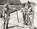 Israeli policemen meet a Jordanian legionnaire near the Mandelbaum Gate. Around 1950