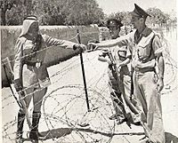 Israeli policemen meet a Jordanian Legionnaire near the Mandelbaum Gate (c. 1950)