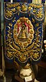 An embroidered processional banner or gonfalon on display at the church museum.