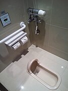 Japanese-style squat toilet with automatic sensor