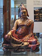 Room 33 - Figure of seated Lama; of painted and varnished papier-mâché, Ladakh, India, 19th century AD