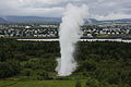 Artificial geyser, Kópavogur in the background.