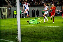 Melis jumps over a goalkeeper