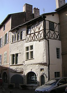 Houses in Cluny, France, one with half-timbering and render.