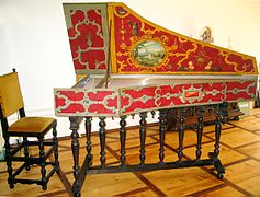 Modern reproduction harpsichord uses bandwork or strapwork motifs based on a Flemish book of 1579, mixed in with grotesque elements.