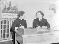 A journalist (left) interviewing a woman in uniform (right) from the Women's Royal Canadian Naval Service, 1943