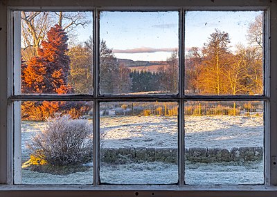 View of the Trossachs countryside through a farm window on a frosty evening