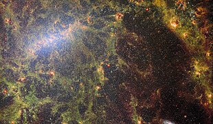 James Webb Space Telescope peers behind the bars to image the bright tendrils of gas and stars of the barred spiral galaxy NGC 5068. The galaxy lies around 17 million light-years from Earth in the constellation Virgo.[22]