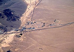 Aerial view of Baker looking north: I-15 jogs south around the town, leaving Baker Boulevard, the main street, to show where the pre-interstate highway (US 91 and US 466) went. Baker Airport sits just north of the city alongside northbound CA 127, the "Death Valley Road".