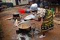 Image 46A Tanzanian woman cooks Pilau rice dish wearing traditional Kanga. (from Tanzania)