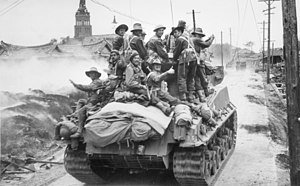 Australian troops riding on a US Army Sherman tank at Sariwon in October 1950