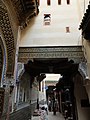 Street on the south side of the zawiya; the bridge or raised passage over the street connects the zawiya building (on the left) directly with the house of the khatib (on the right)