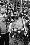 Jim Clark waving the camera in celebrating winning a race