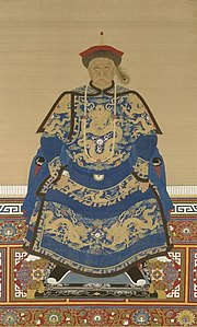 Full-face painted portrait of a severe-looking sitting man wearing a black-and-red round cap adorned with a peacock feather and dressed in dark blue robes decorated with four-clawed golden dragons