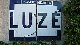 An old Michelin name board, entering Luzé