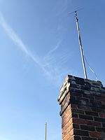 A rabbit ear indoor antenna weatherproofed and installed outdoors