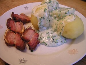 Stegt flæsk is a Danish national dish of fried pork belly generally served with potatoes and parsley sauce (persillesovs).