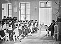 Girls study tailoring in colonial school (Ecole Normale d'Institutrices)