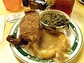 Fried catfish, mashed potatoes and gravy, and greens