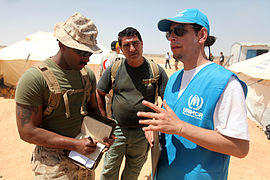 An UNHCR-officer talks with a Marine during Exercise Eager Lion 12.
