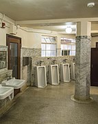An example of floor standing urinals in a men's bathroom