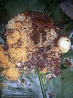 Waakye (rice and beans) served with spaghetti and boiled egg