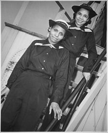 Olivia Hooker & Aileen Anita Cooks, two African American SPARS, pause on the ladder of the dry-land ship U.S.S. Neversail