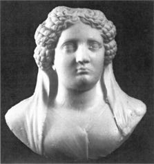 Black and white image of the face and upper torso of a sculpted woman
