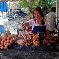 Chicken, pork and eggs being grilled at a small restaurant at the entrance of Huay Kaew waterfall, Chiang Mai, Thailand