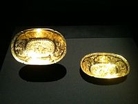 Two Tang oval-lobed gold bowls each with two ducks in repoussé among chased flowers