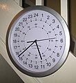 A modern quartz clock with a 24-hour face