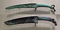 Shang dynasty curved bronze knives with turquoise inlays and animal pommel.[18]
