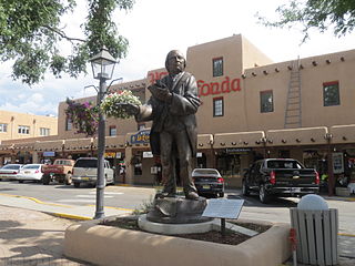 Taos Plaza and La Fonda Hotel, with sculpture of Padre Jose Antonio Martinez in the foreground