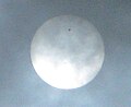 13. The June 2012 Transit of Venus, as seen from Hong Kong. Venus is the distinct, black dot near the top of the Sun, while 2 sunspots can be seen as small, faint black dots near the brighter bottom half of the photo, below Venus. This image was taken by User:Earth100.