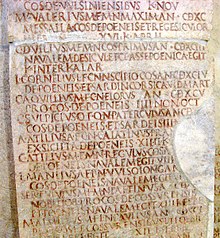 a stone slab, densely engraved with Latin text