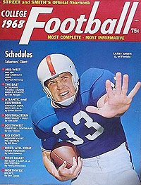 Color rendering of 1968 cover of Street & Smith magazine, showing a close-up of football player Larry Smith in the royal blue, white and orange uniform of the Florida Gators, carrying a football in one hand with the other outstretched toward the camera.