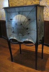 Stylized Art Deco festoons on a commode, by Paul Iribarne Garay, c.1912, mahogany and tulip wood frame, slate top, green-tinted shagreen upholstery, ebony knobs, base and garlands, Museum of Decorative Arts, Paris