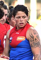 Female athlete with tattooed arms in guernsey