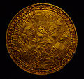 A bracteate likely depicting Odin, with a raven, his horse, and an ornate Suebian knot with the heathen Alu formula.