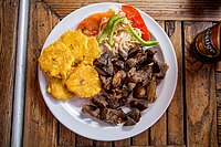 Griot is a Haitian dish of pork shoulder marinated in citrus before being braised and fried.