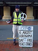 An anti-nuclear activist hands out peace cranes in Wellington. New Zealand's foreign policy is often symbolised by its anti-nuclear stance.