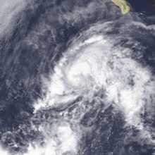 A satellite image of a sprawling but disorganized tropical storm over the Eastern Pacific Ocean