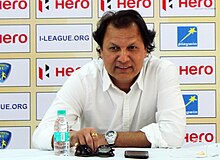 Photograph of Santosh Kashyap looking straight on at a press conference.
