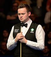 Picture of Shaun Murphy standing by a snooker table