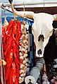 Symbols of the Southwest — a string of chile peppers and a bleached white cow's skull hang in a market near Santa Fe.