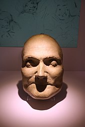 Colour photograph of the plaster cast death mask of William Hunter. His eyes are closed and he is unsmiling.