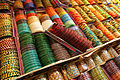 Image 15 Bangles Photograph: Muhammad Mahdi Karim Bangles on display in Bangalore, India. These rigid bracelets are usually made from metal, wood, or plastic and are traditionally worn by women in India, Nepal, Pakistan, and Bangladesh. In India, it is a common tradition to see a new bride wearing glass bangles at her wedding and the honeymoon will end when the last bangle breaks. More selected pictures